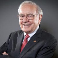 warren buffett in a suit smiling