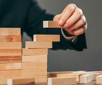 stock-photo-man-and-wooden-cubes-on-table-management-concept-795987892