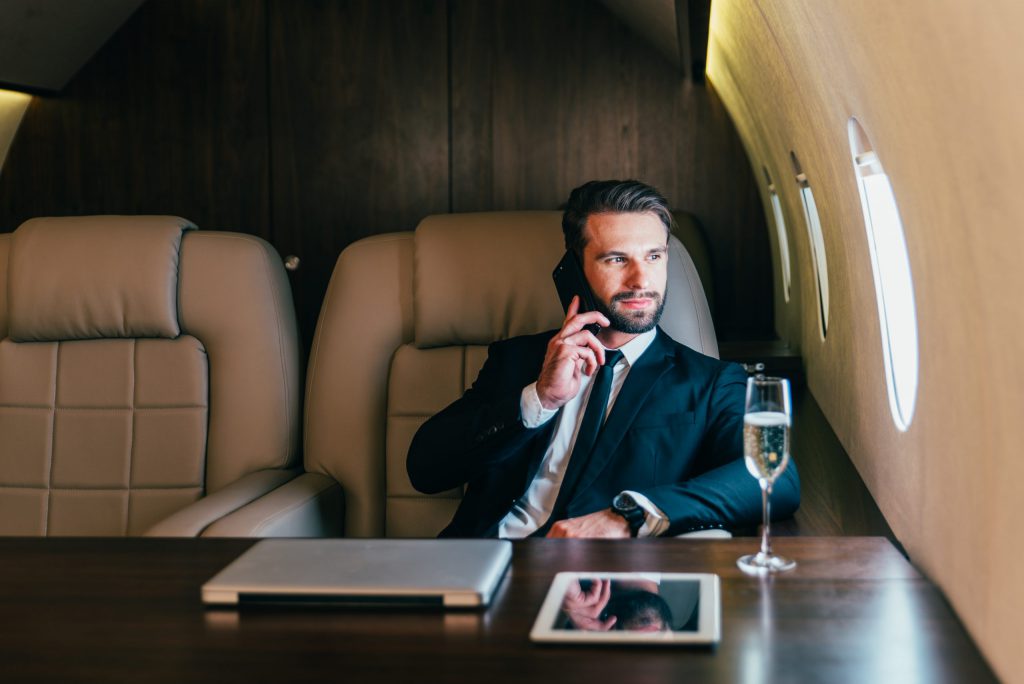 a business investor on the phone in front of his laptop